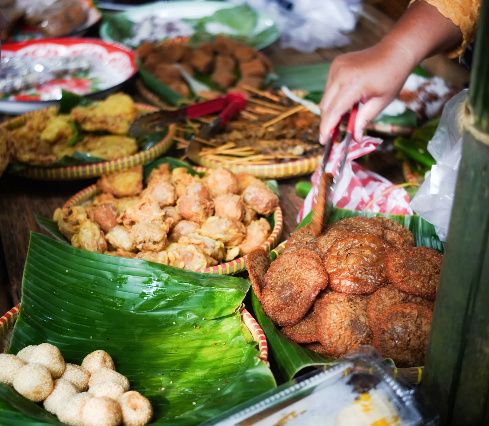 Vendor serving Indonesian street food snacks
