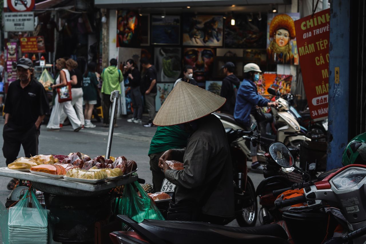 Street food vendor preparing pho in Vietnam, rice noodles are gluten-free but condiments and broth additives can contain wheat