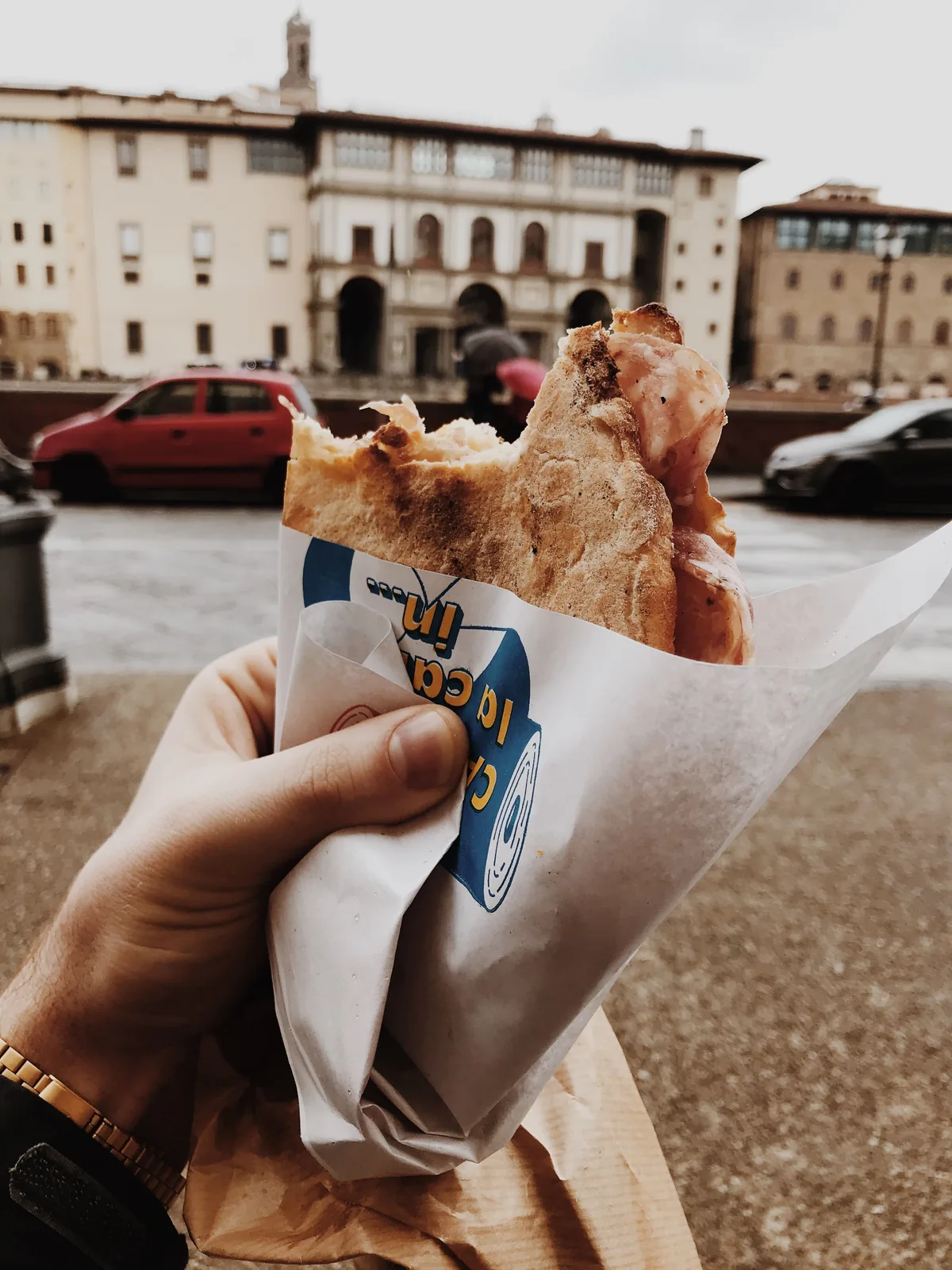 Holding a street food sandwich in Florence, Italy