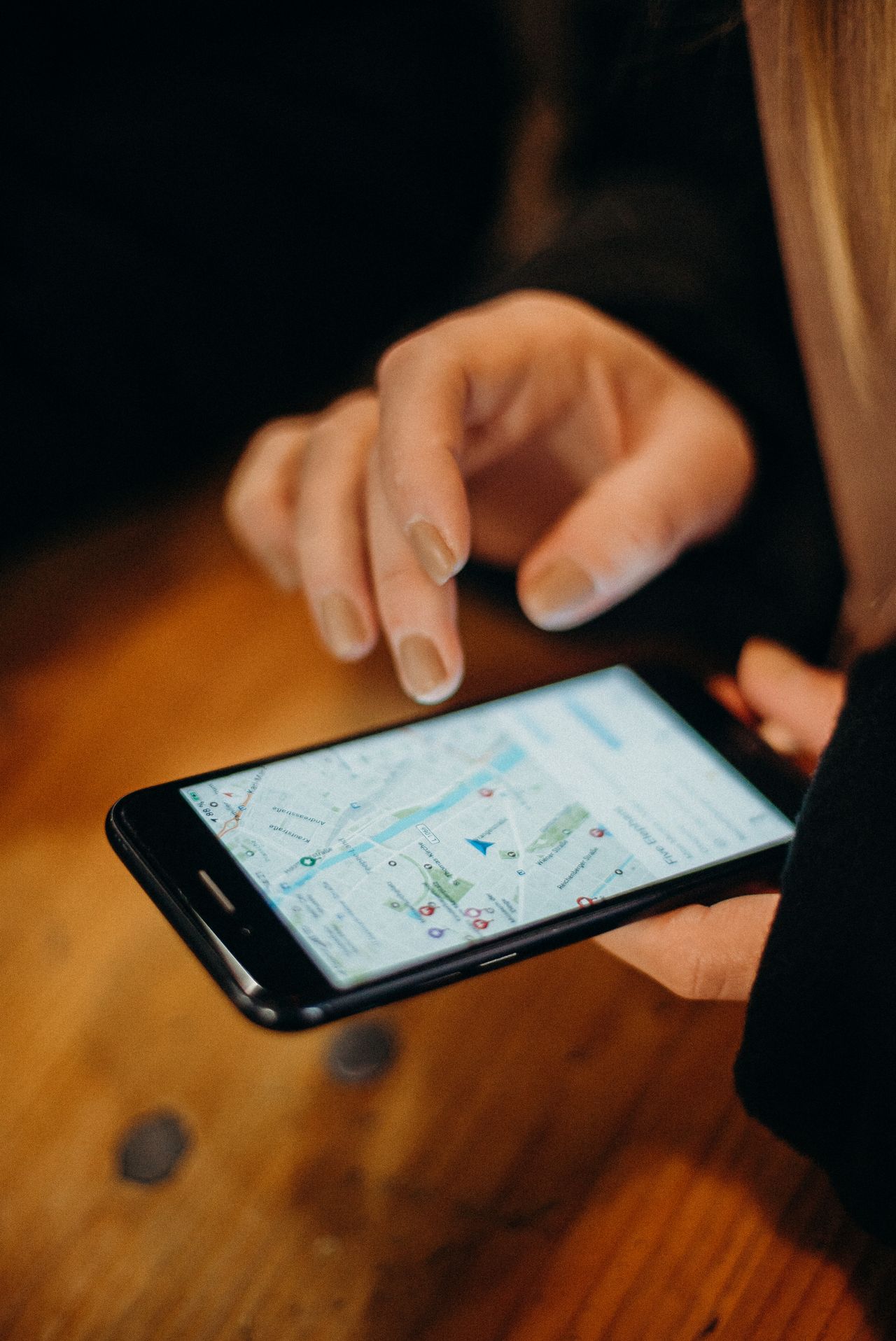 Hand holding a smartphone showing map navigation