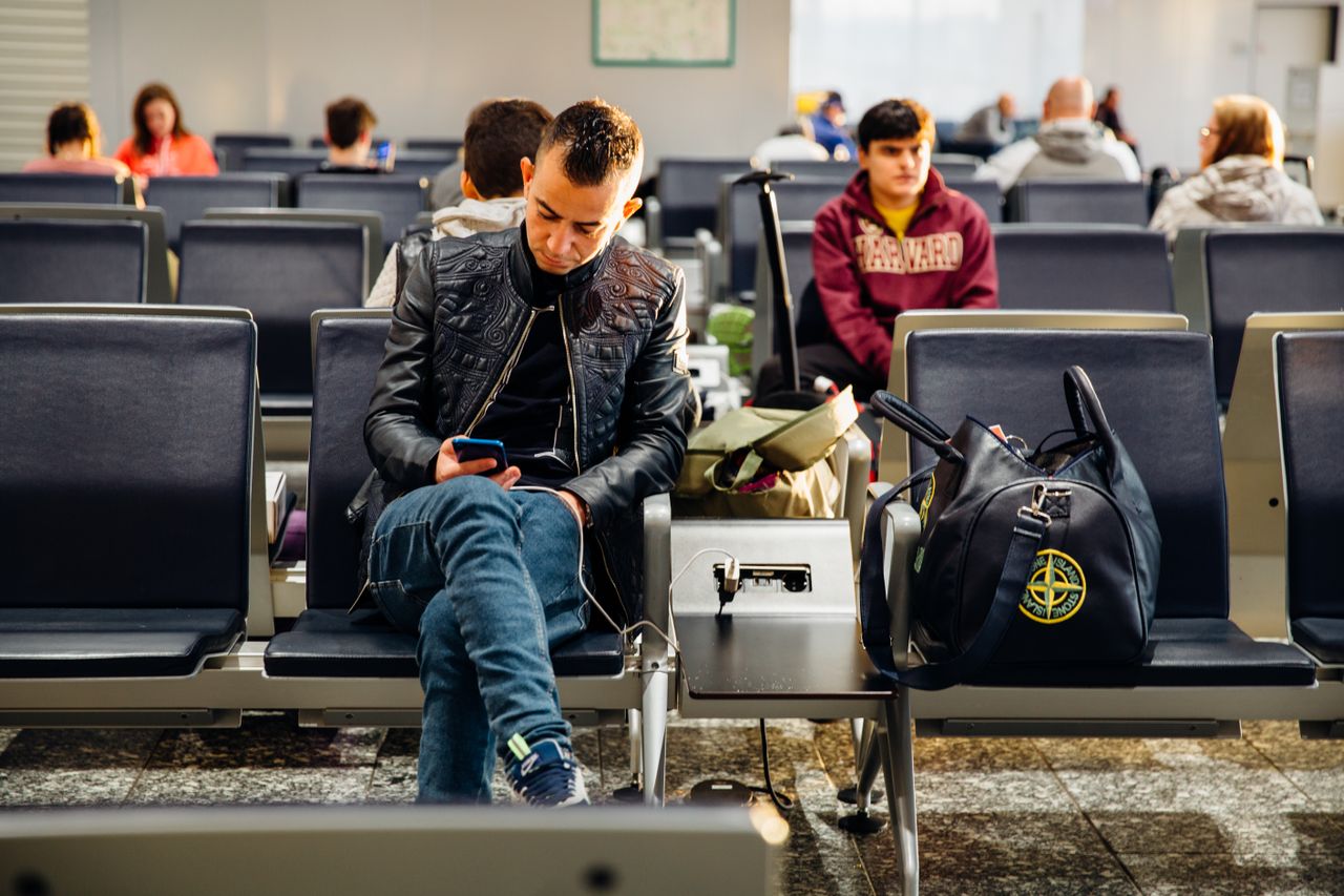 Solo traveler with luggage at an airport departure hall: first-time food allergy travel guide